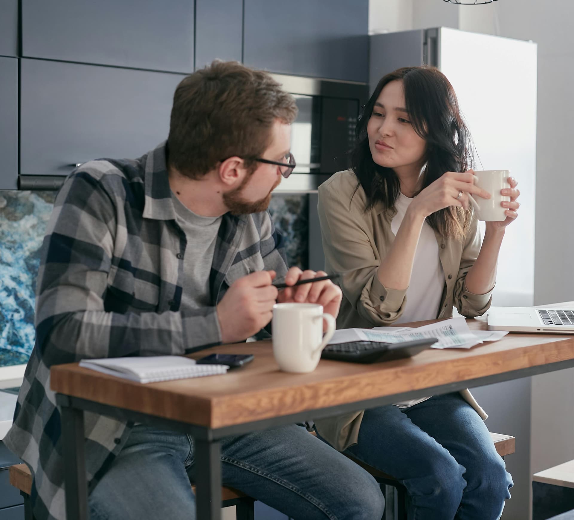 Couple reviewing their monthly finances at the kitchen table